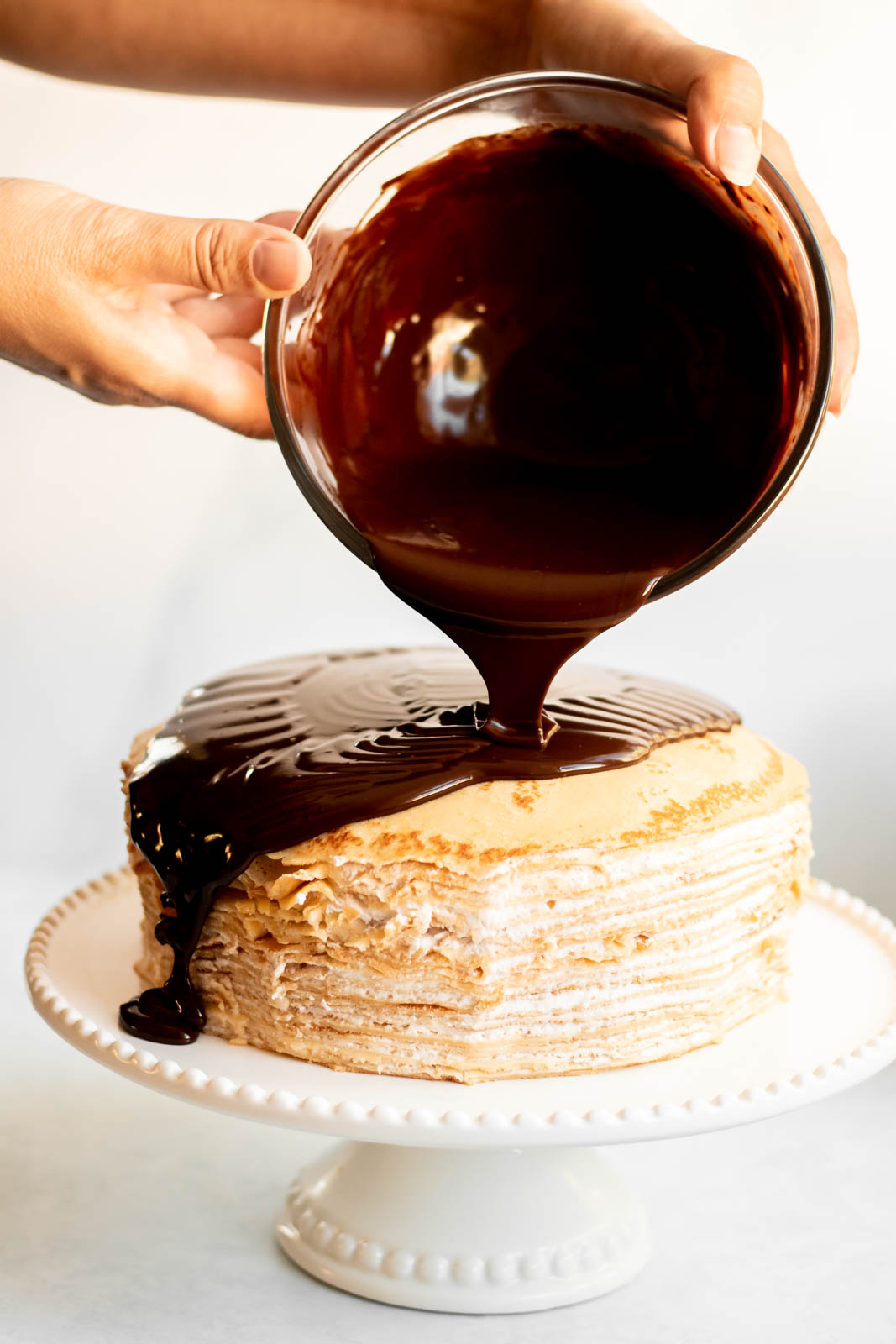 Chocolate ganache poured on a crepe cake.