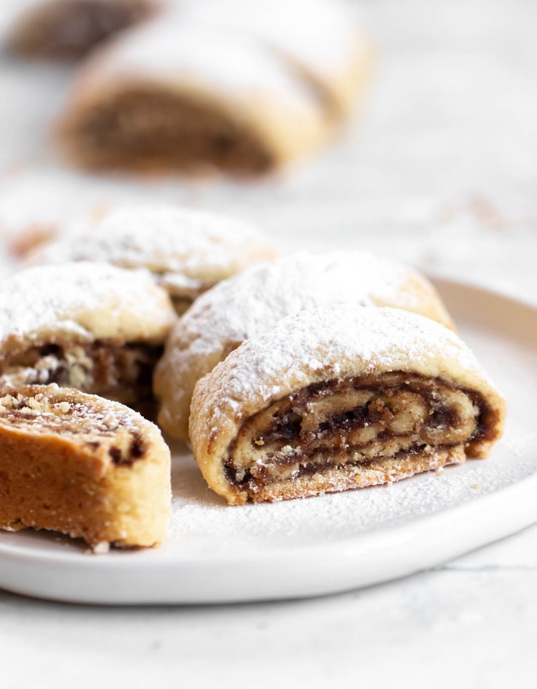 Date roll cookies on a white plate.