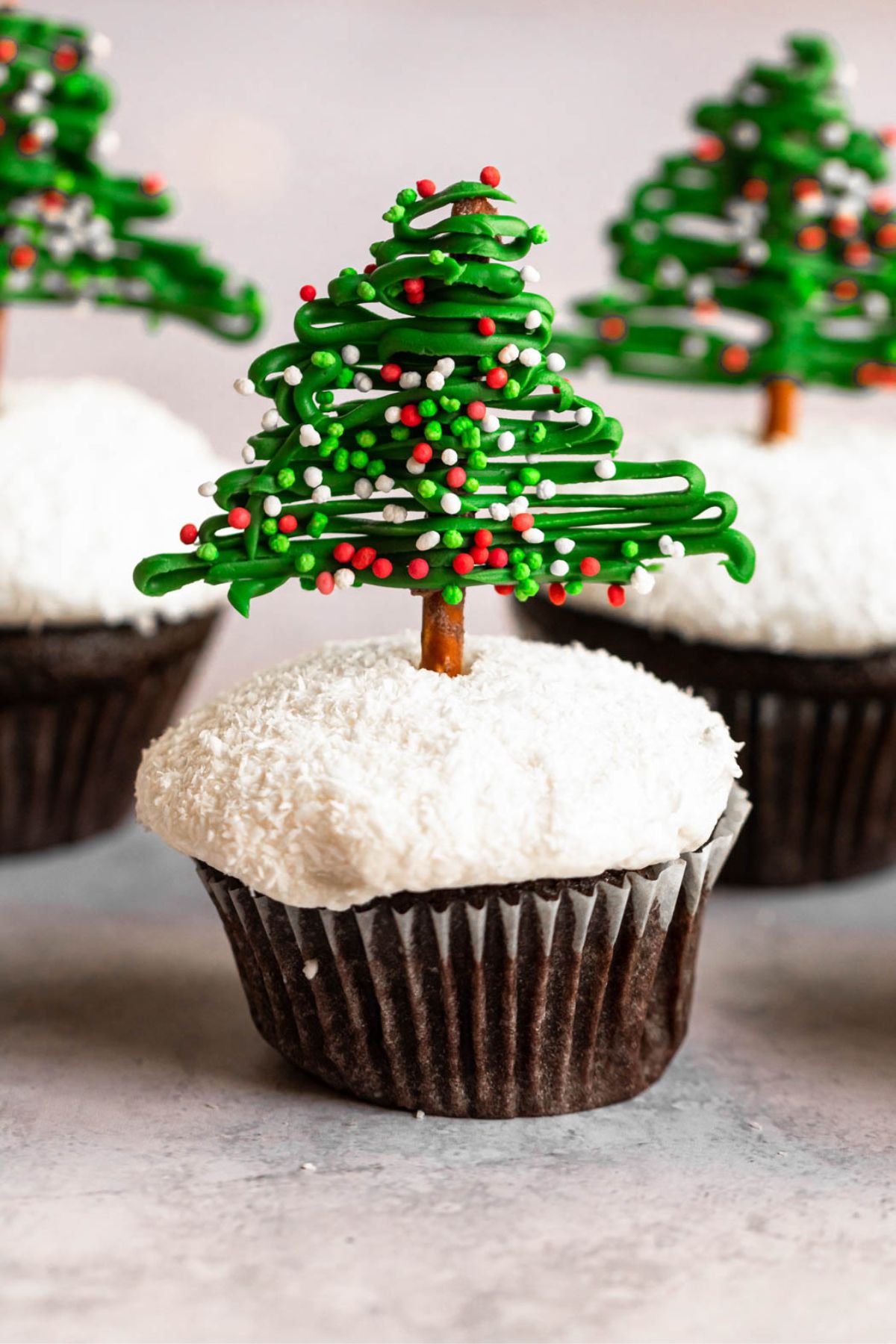 Christmas tree cupcakes on a white backround.