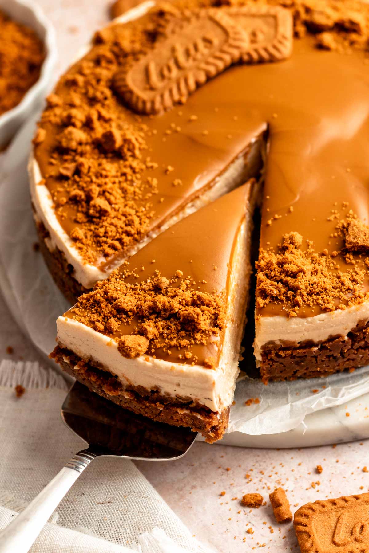Slice pulled away from a cookie butter cheesecake.