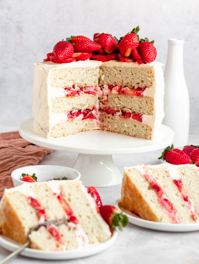 strawberry jam cake with two slices of cake next to it.