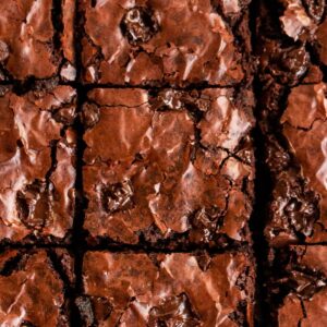 Overhead shot of fudgy brownies with chocolate chunks on top.