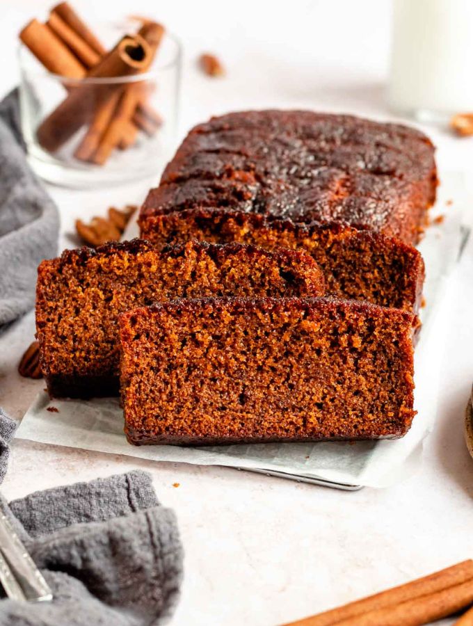 Sliced loaf of honey cake on a parchment paper.