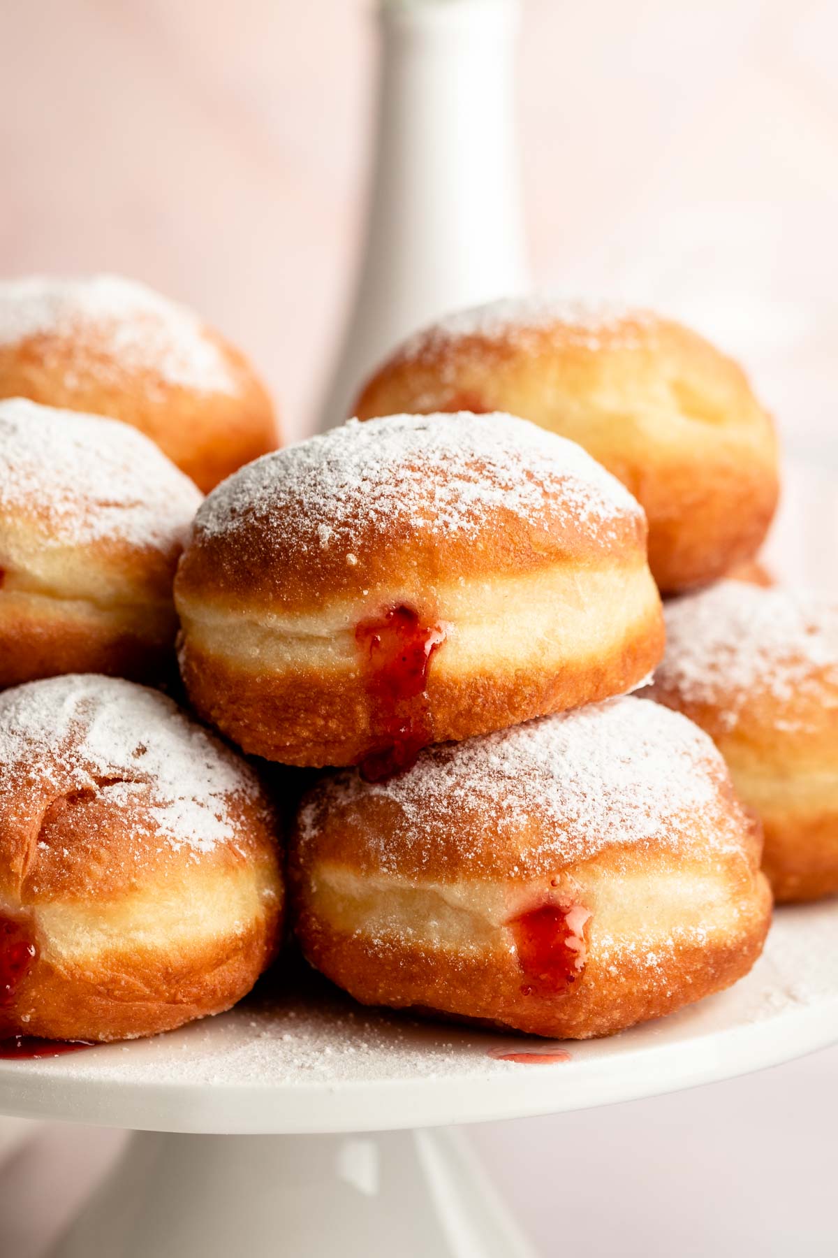 Stack of sufganiyot filled with strawberry jelly.