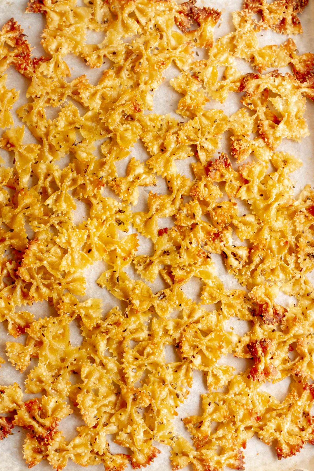 Overhead shot of pasta chips on a cooking sheet.