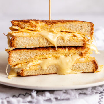 french toast omelette sandwich sliced in half on a plate