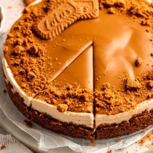 Biscoff cheesecake on a cake plate.