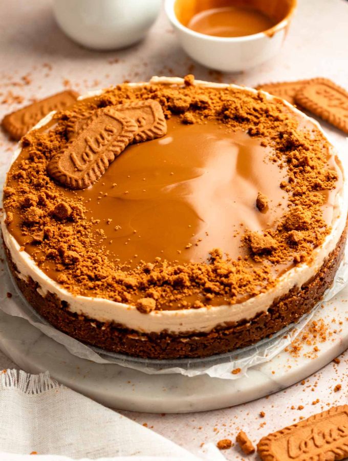Biscoff cheesecake on a cake plate.
