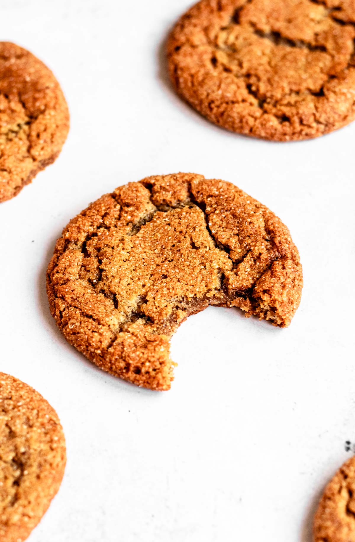 Bite missing from a ginger molasses cookie.