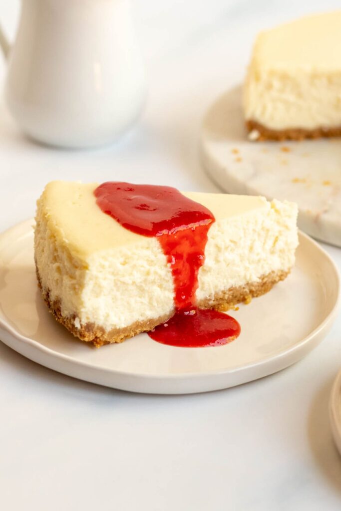 Slice of cheesecake with strawberry topping.