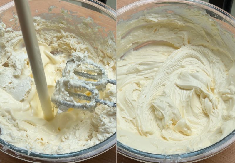 An electric hand mixer beating cold heavy cream directly into a cream cheese base until it forms thick, stiff peaks.