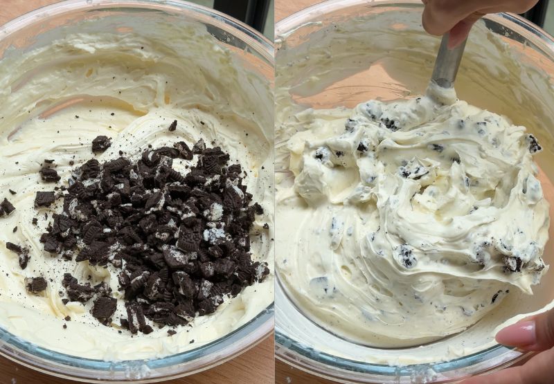 Coarsely chopped chocolate sandwich cookies being stirred into a thick, creamy cheesecake filling.