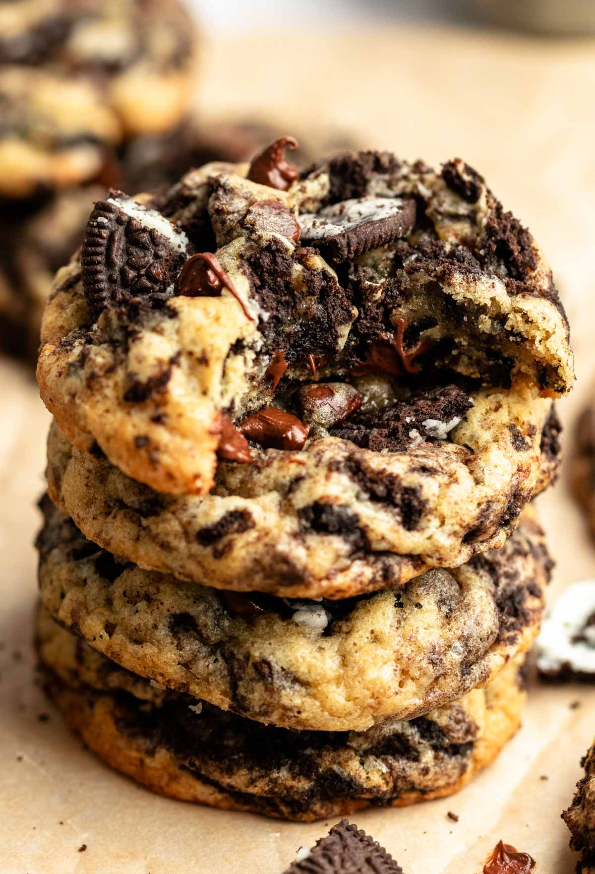 Stack of oreo chocolate chip cookies with the top cookie missing a bite.