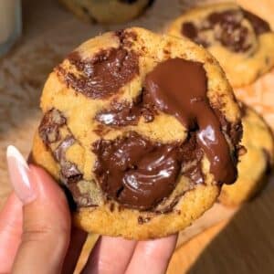 Hand holding a small batch chocolate cookie.