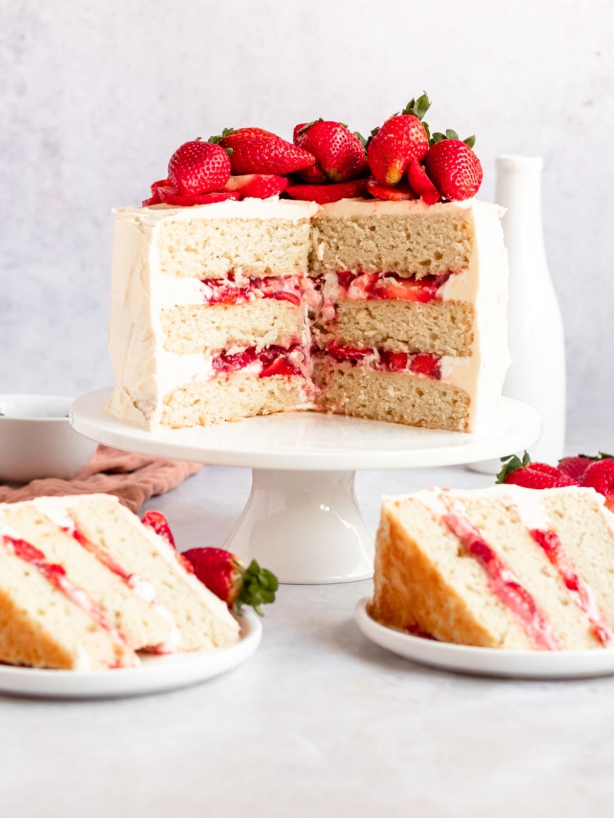 Strawberry jam cake with strawberries on top sliced.