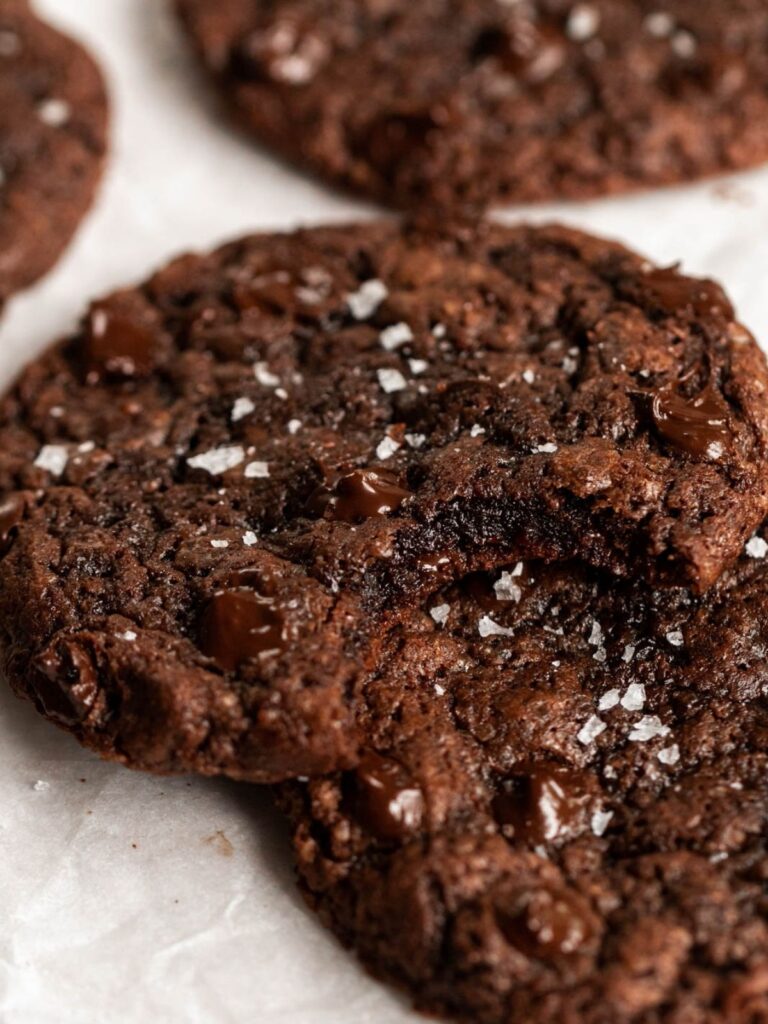 Close up shot of chewy chocolate cookie with a bite missing.