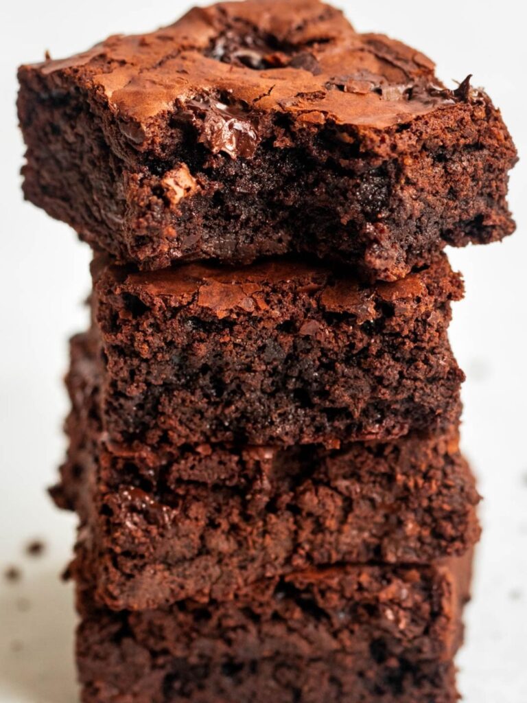 Stack of brownies with a bite missing from the top brownie.
