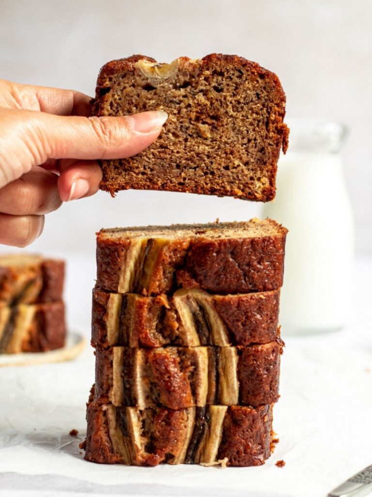 Banana bread stack with one slice lifted.