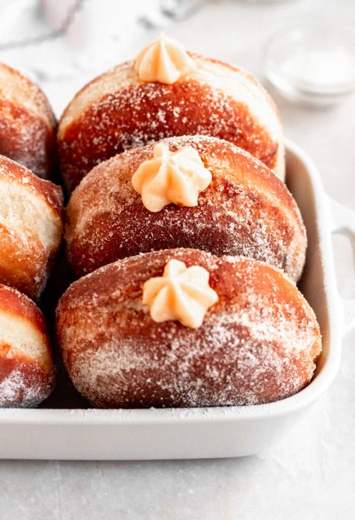 Bavarian cream donuts in a baking dish.