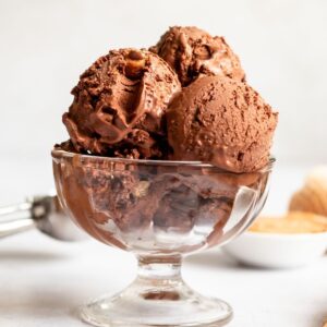 Peanut butter chocolate ice cream balls in a glass bowl.