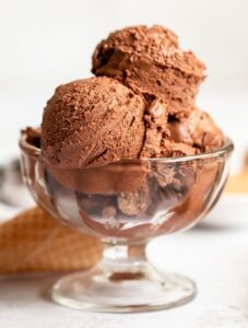 Peanut butter chocolate ice cream balls in a glass bowl.