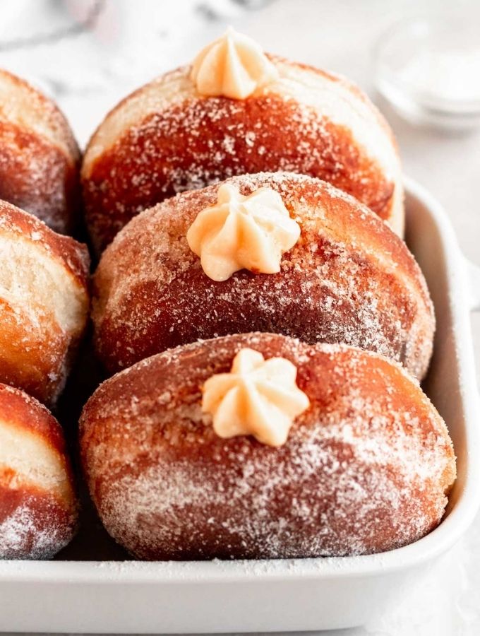 Bavarian cream donuts in a baking dish.