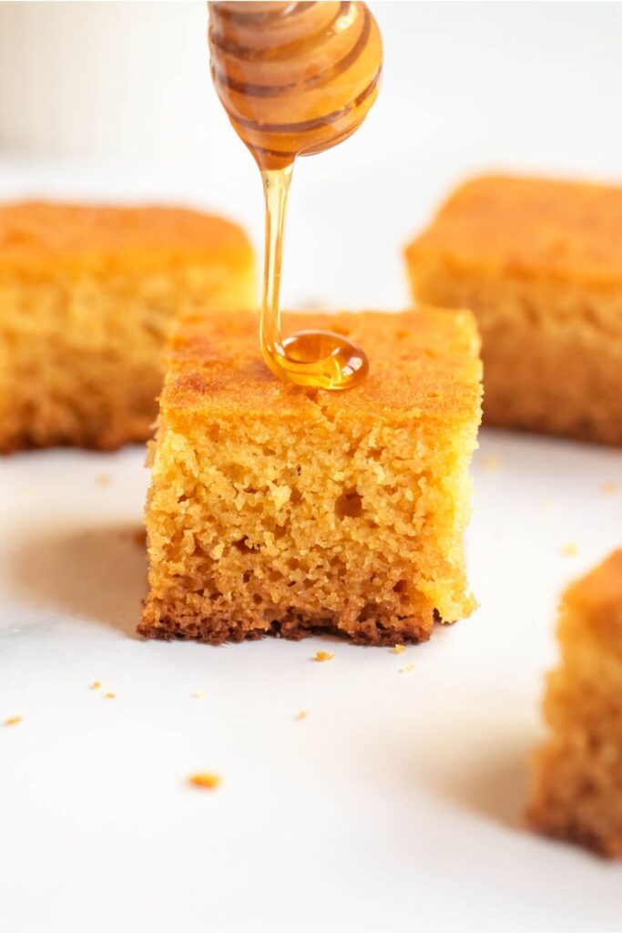 Drizzle of honey on a piece of buttermilk cornbread.
