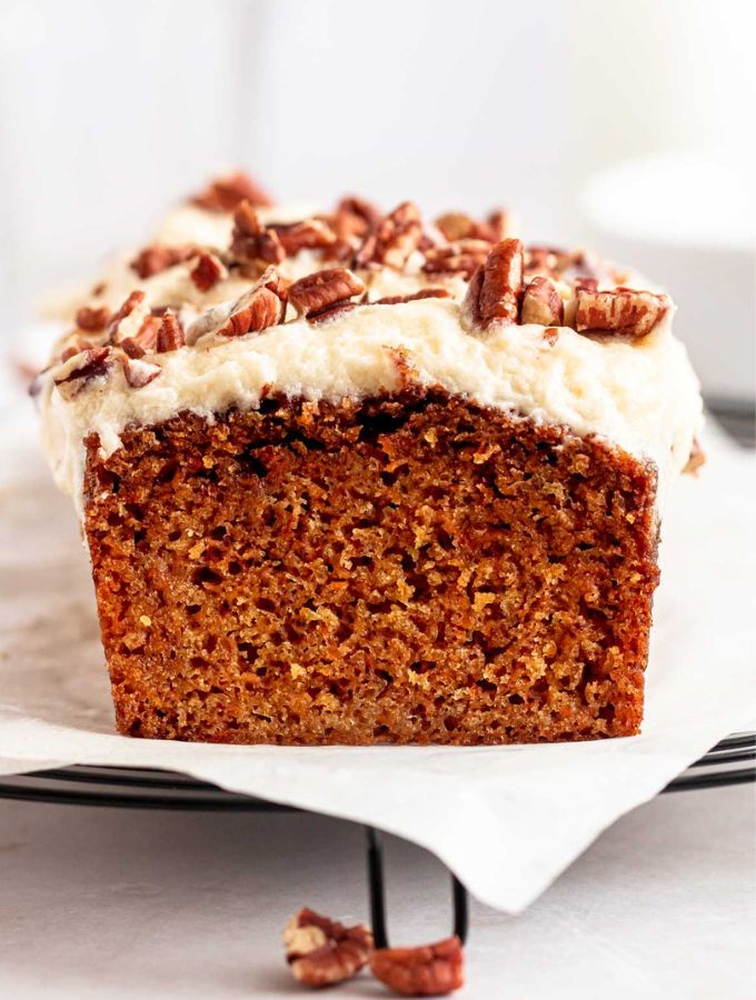 Sliced carrot cake loaf on a parchment paper.