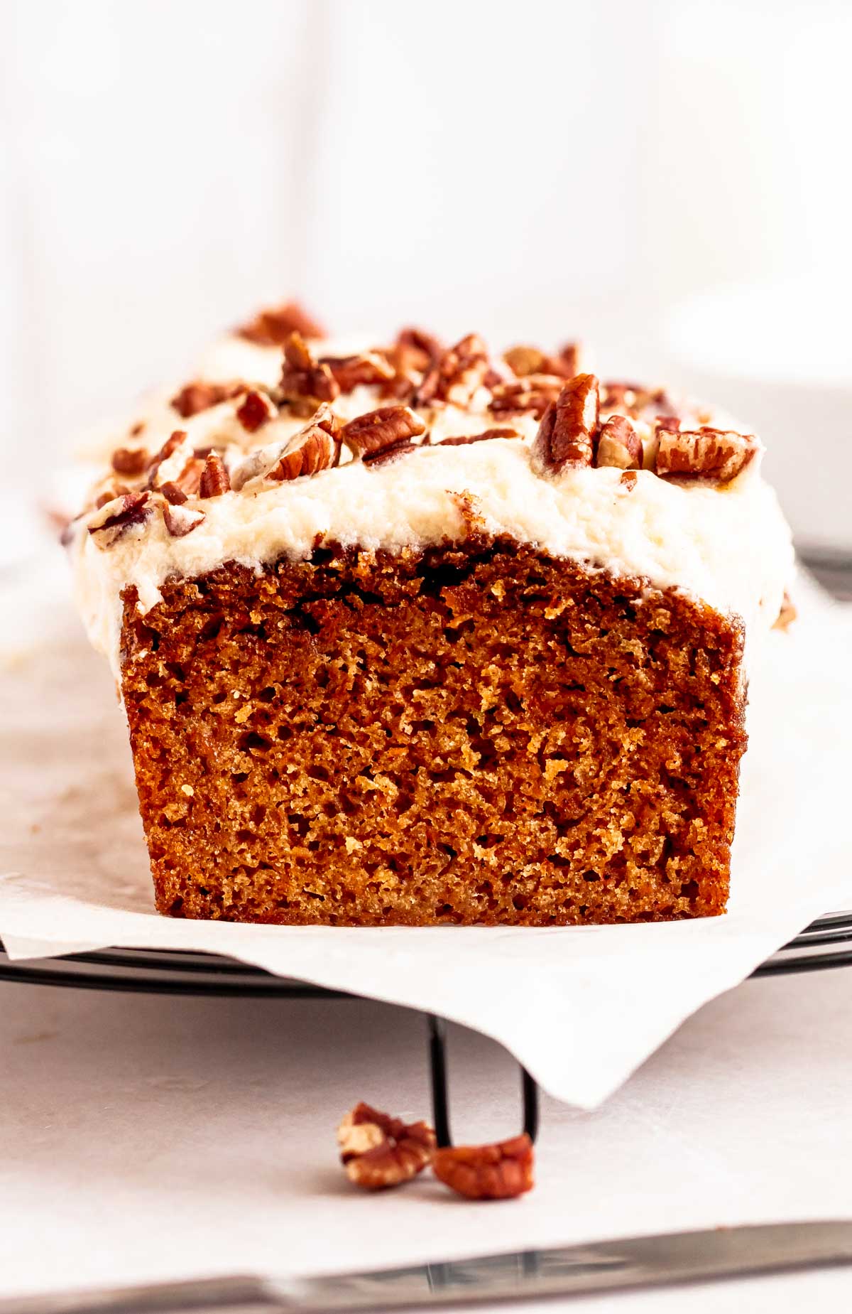 Sliced carrot cake loaf on a parchment paper.