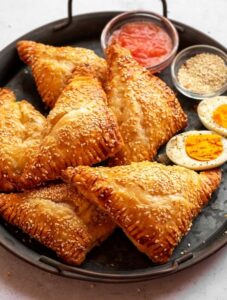 Cheese bourekas on a gray plate.