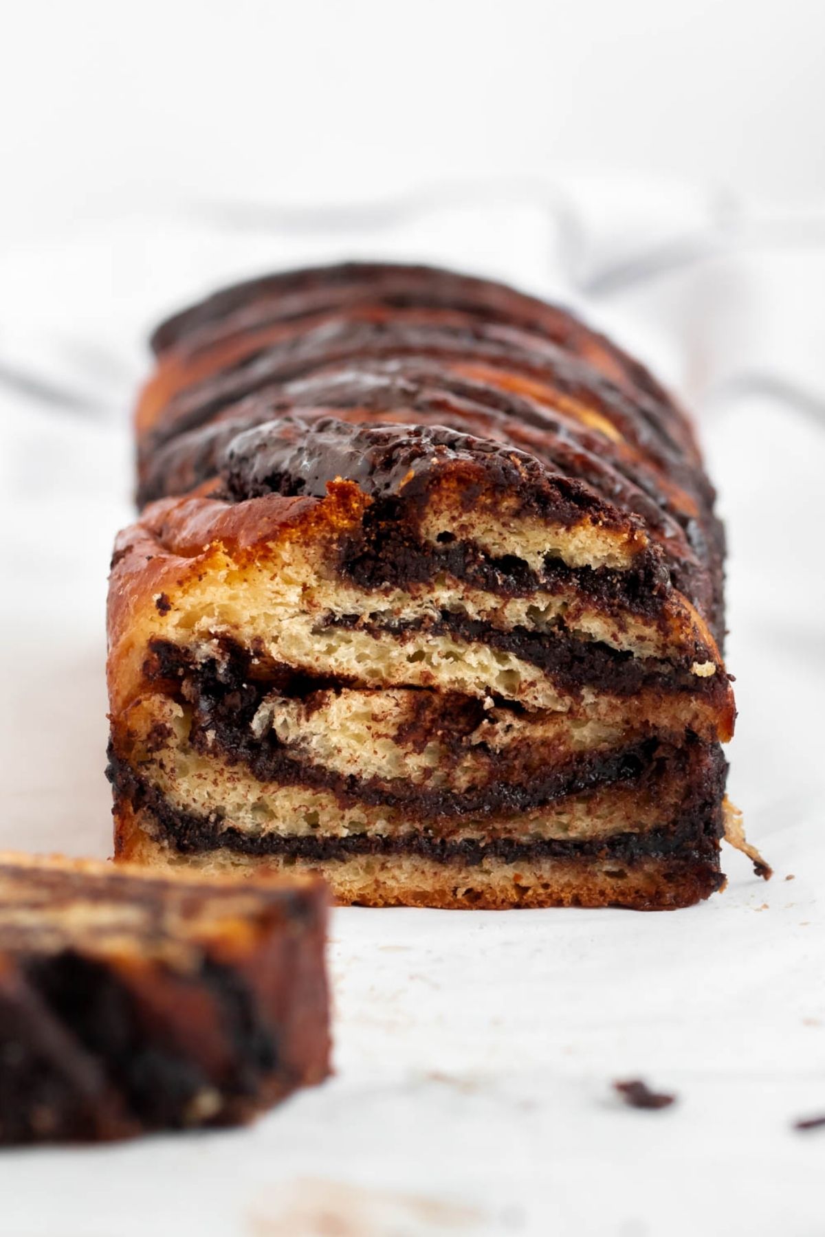 Chocolate babka loaf with a slice on the side.