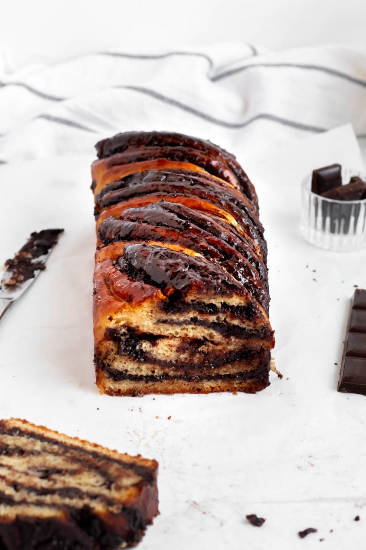 Loaf of chocolate babka on a white backround.