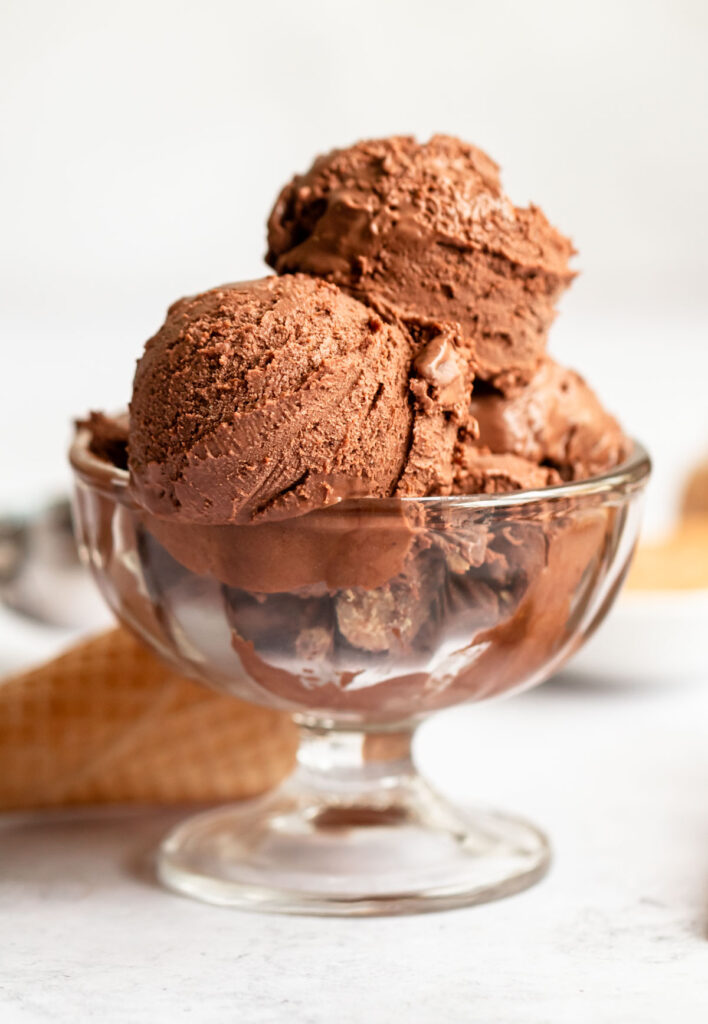 Peanut butter chocolate ice cream balls in a glass bowl.