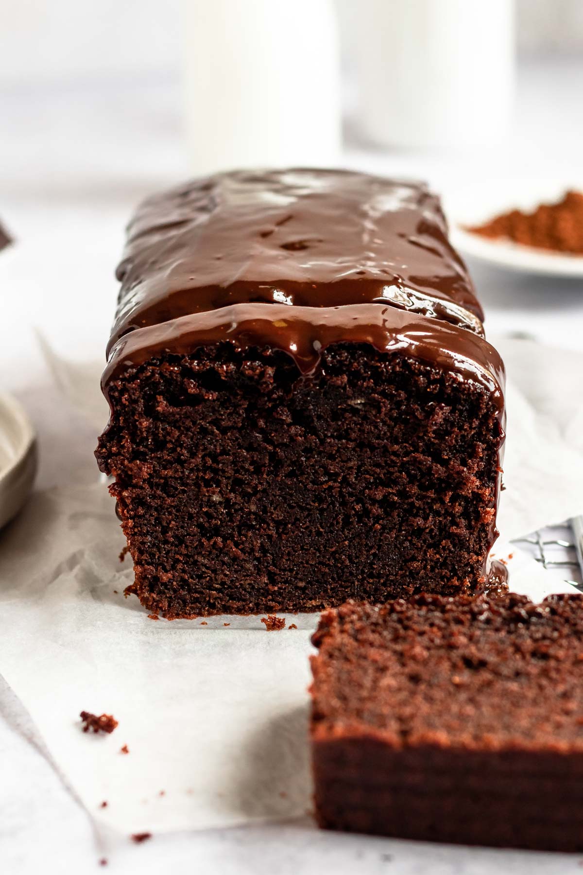 Sliced chocolate pound cake with sour cream on a parchment paper.