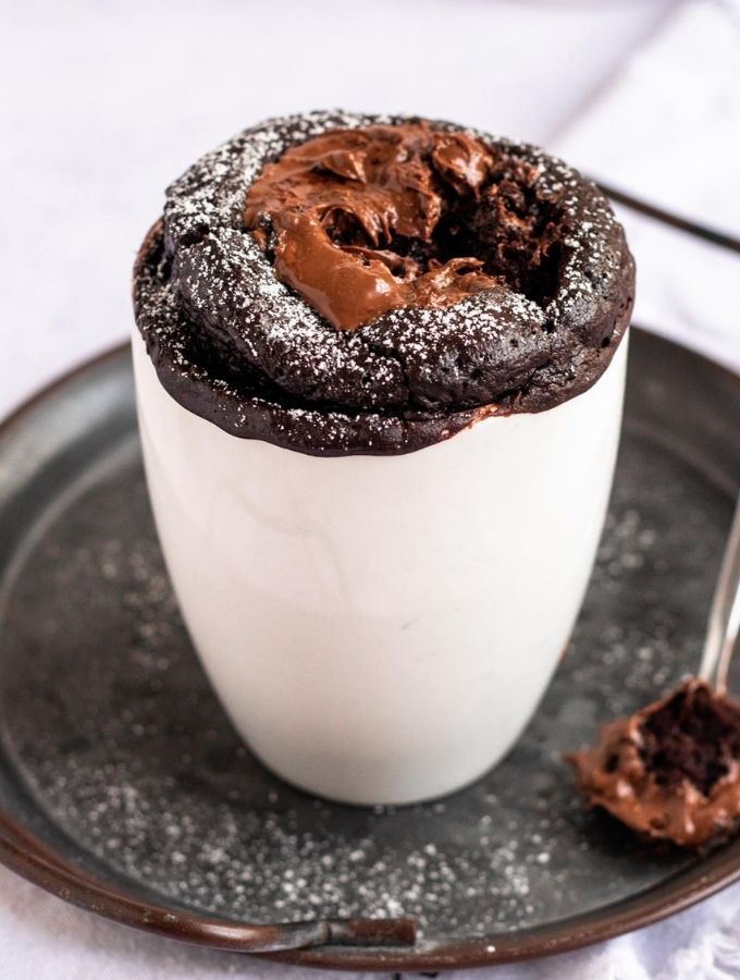 Nutella mug cake with a bite missing.