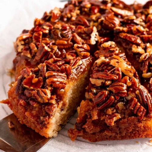 Slice pulled out from pecan uside down cake.