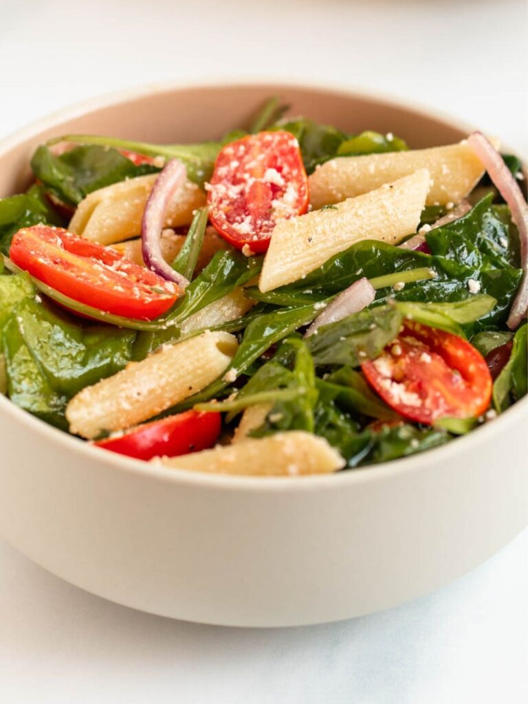 Spinach pasta salad in a bowl.