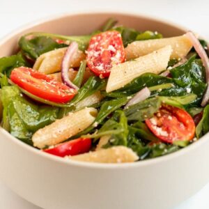 Spinach pasta salad in a bowl.