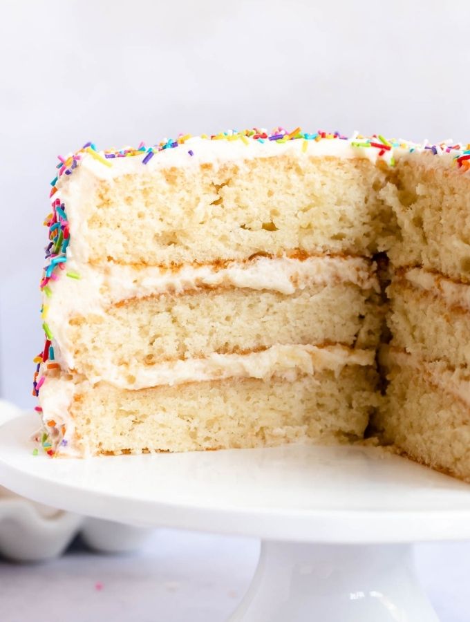 3 layer 8 inch vanilla cake on a white cake platter.