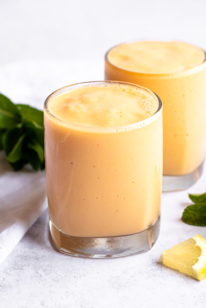 Two cups of mango pineapple smoothie.