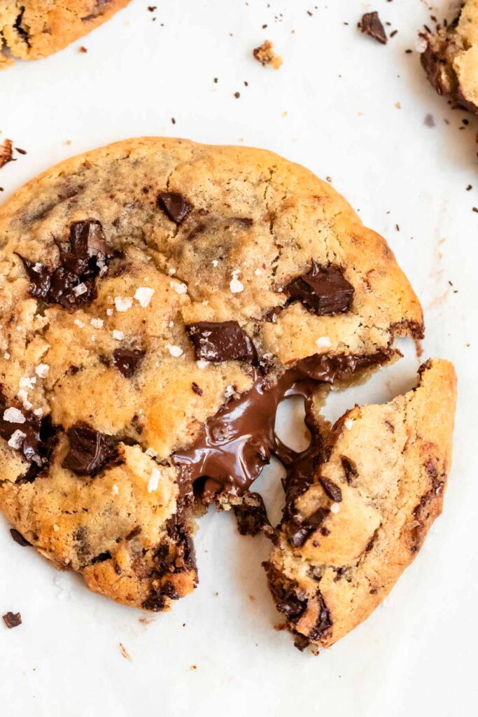 Cookie cut in half with nutella pouring out of it.