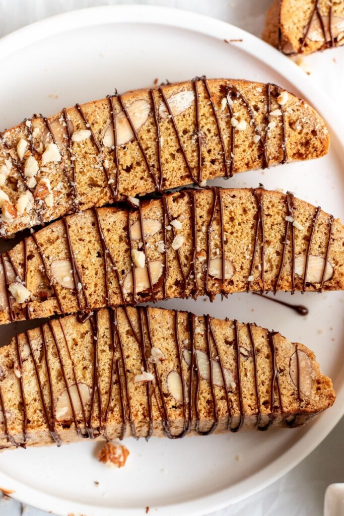 Close up shot of almond biscotti drizzled with chocolate.