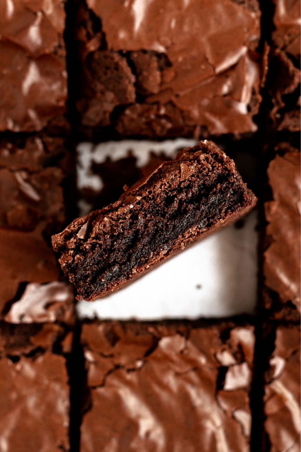 Top of dairy-free brownies with the middle on showing the fudgy center.