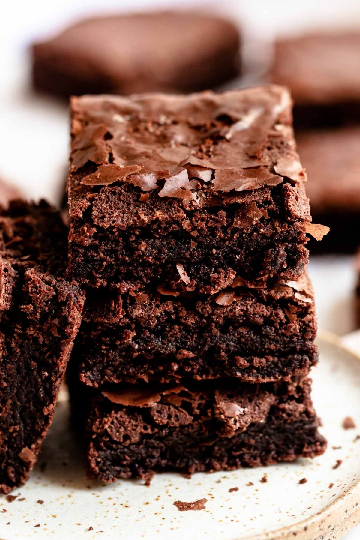 Stack of dairy-free brownies with a crackly top.