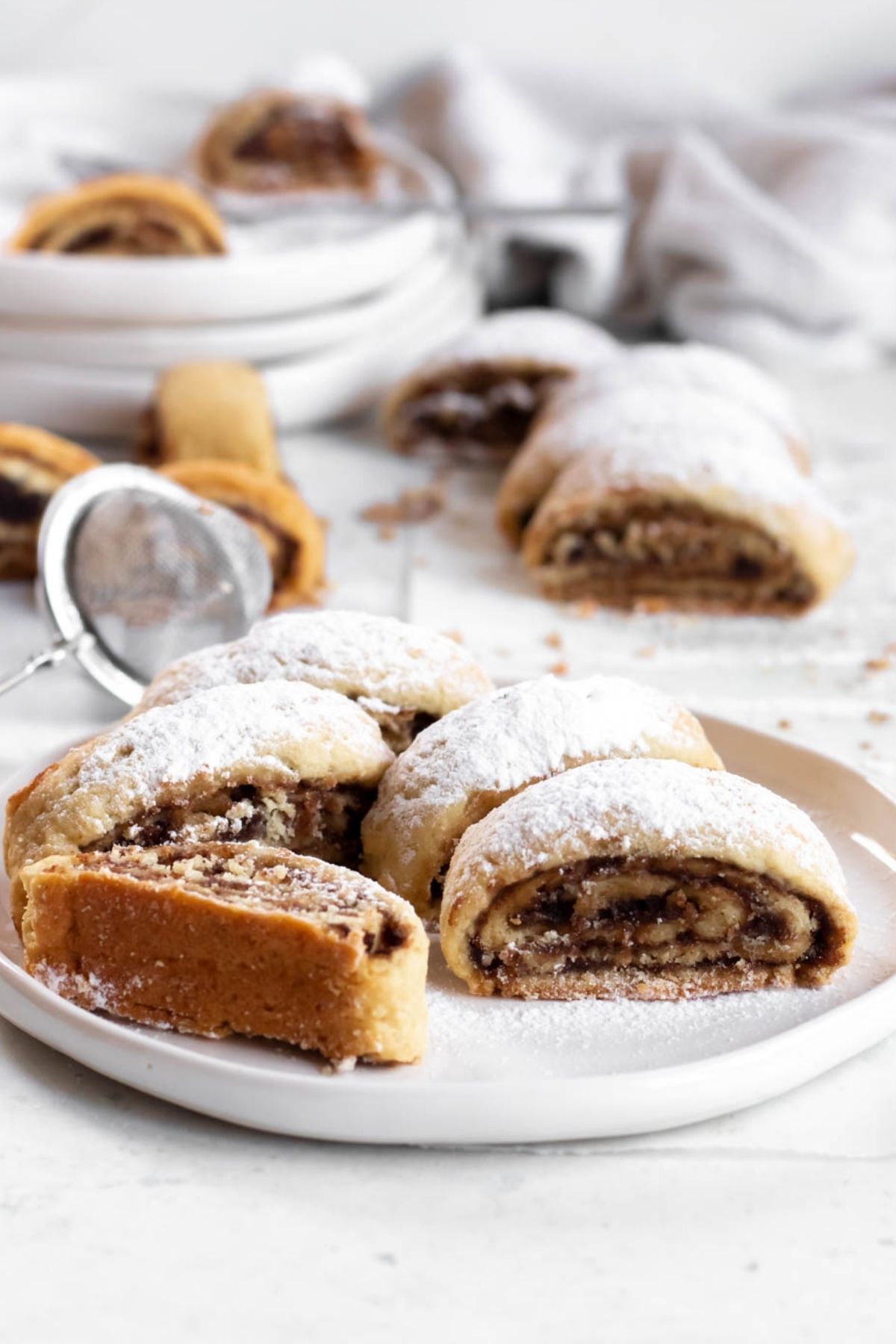 Date roll cookies on a white plate.