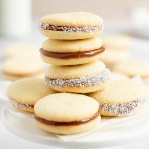 Stack of dulce de leche cookies on a small platter.