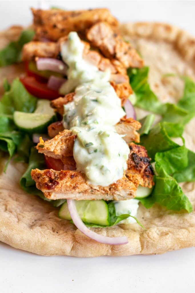 Pita with gyros chicken on top.