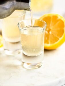 Pour shot of green tea shot poured into a shot glass.