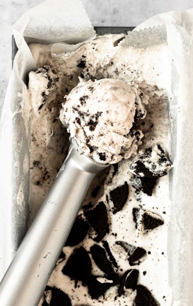 Scoop of ice cream in an oreo ice cream container.