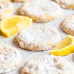 Lemon cooler cookies on a white backround with lemon slices.
